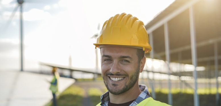 Young man working at renewable energy farm - Eco and enviroment concept - Focus on face Young man working at renewable energy farm - Eco and enviroment concept - Focus on face